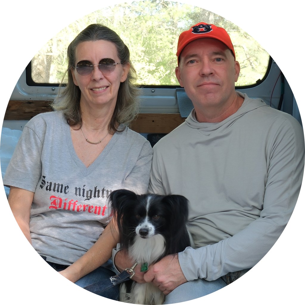 Scott and Deborah with their dog Edgar in the van.